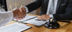 Lawyers shake hands with business people to seal a deal with partner lawyers. or a lawyer discussing