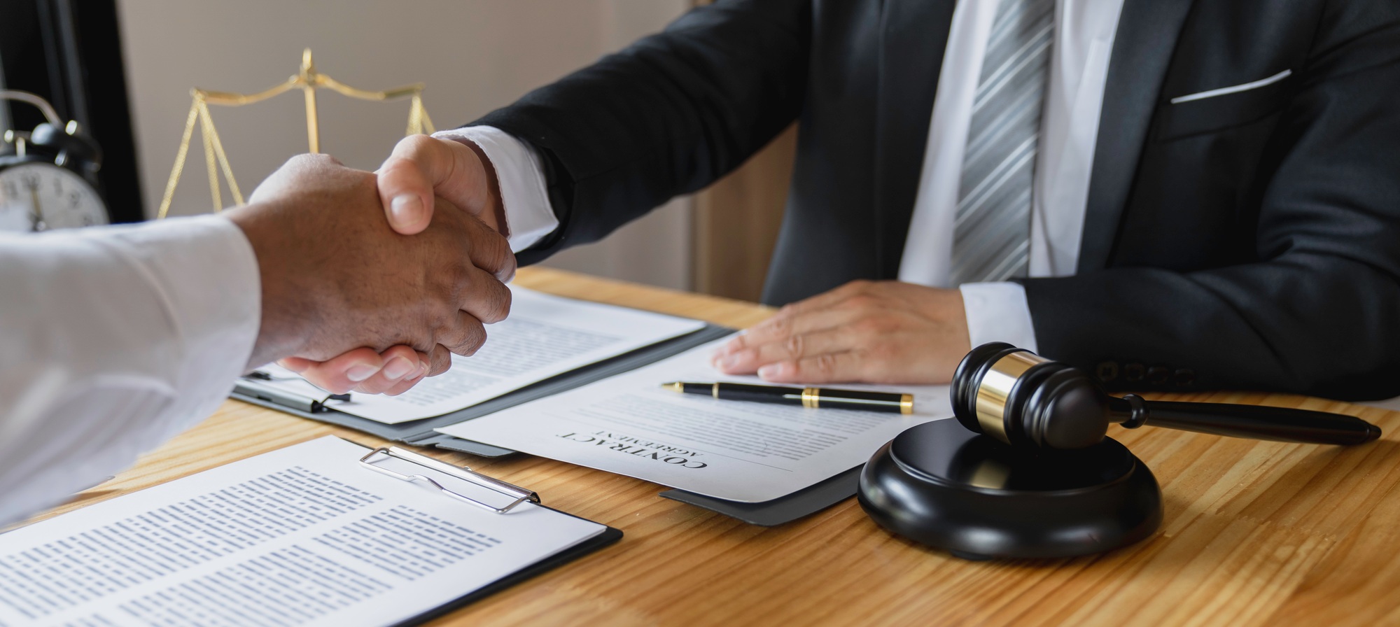 Lawyers shake hands with business people to seal a deal with partner lawyers. or a lawyer discussing